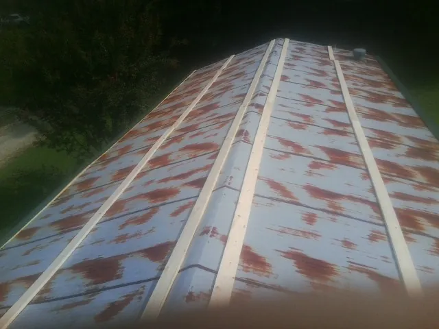 Rusted metal roof panels with new wood purlins before replacement — Storm Damage Roof Repair in Sugar Land by Roofing Brothers